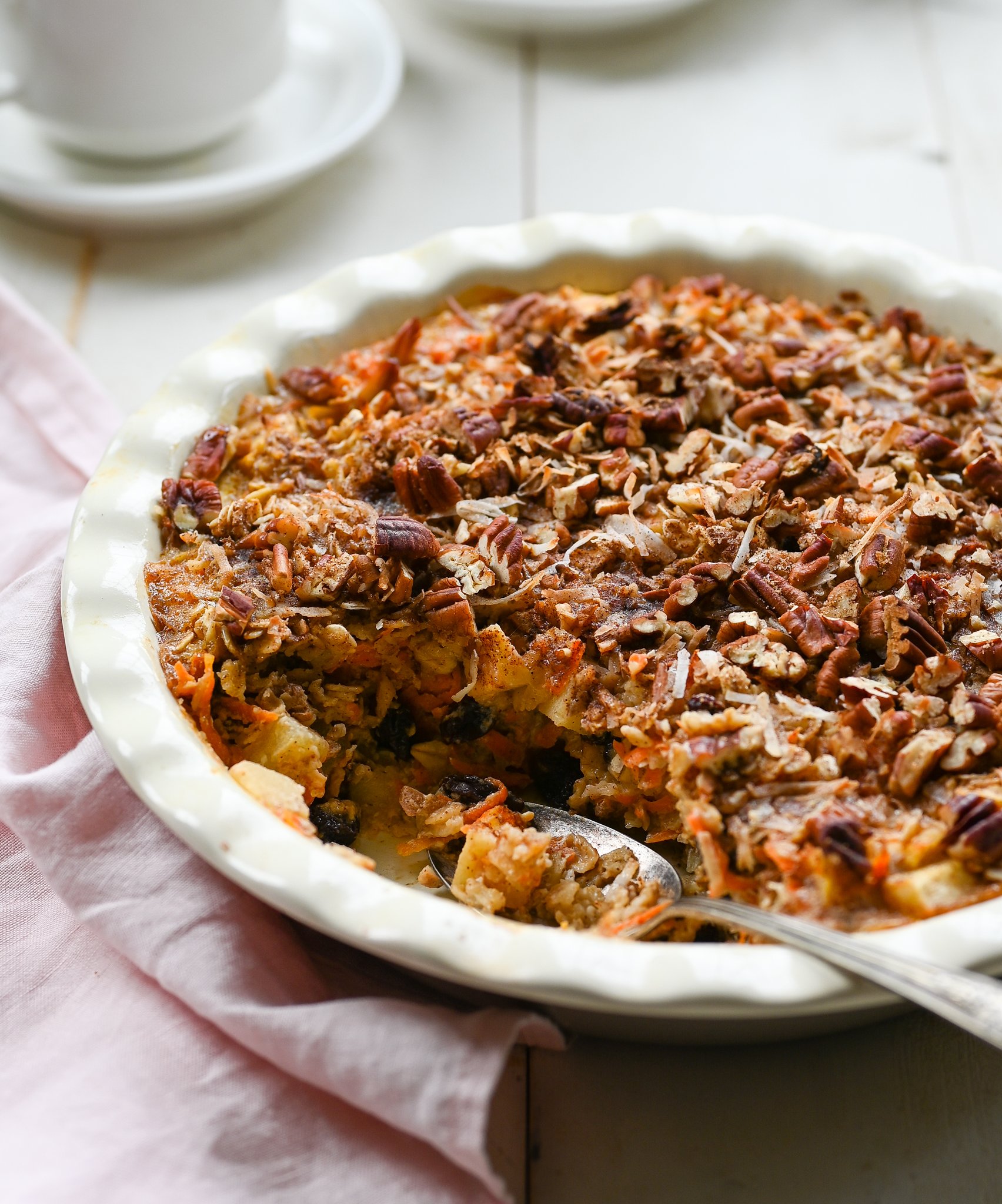 Spoon in a partially-served dish of baked oatmeal.