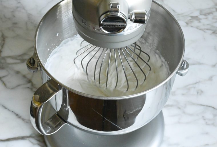 Heavy cream whipping in a mixer.