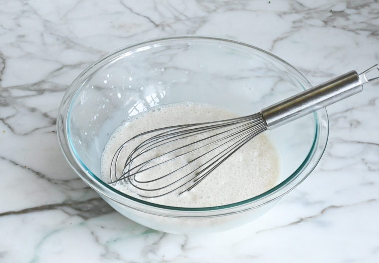 whisked water and sweetened condensed milk in bowl
