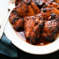 Barbeque-spiced chicken thighs with tangy honey glaze on a plate.