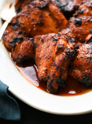 Barbeque-spiced chicken thighs with tangy honey glaze on a plate.