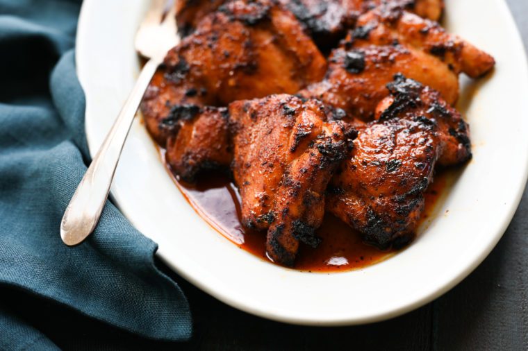 Barbeque-spiced chicken thighs with tangy honey glaze on a plate.