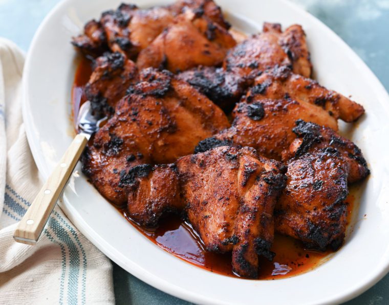 Barbeque spiced chicken thighs on a serving platter.
