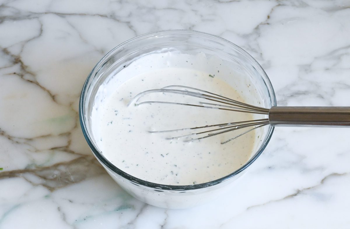 blue cheese dressing in mixing bowl.
