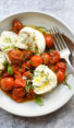 Plate of slow-roasted cherry tomatoes and burrata.