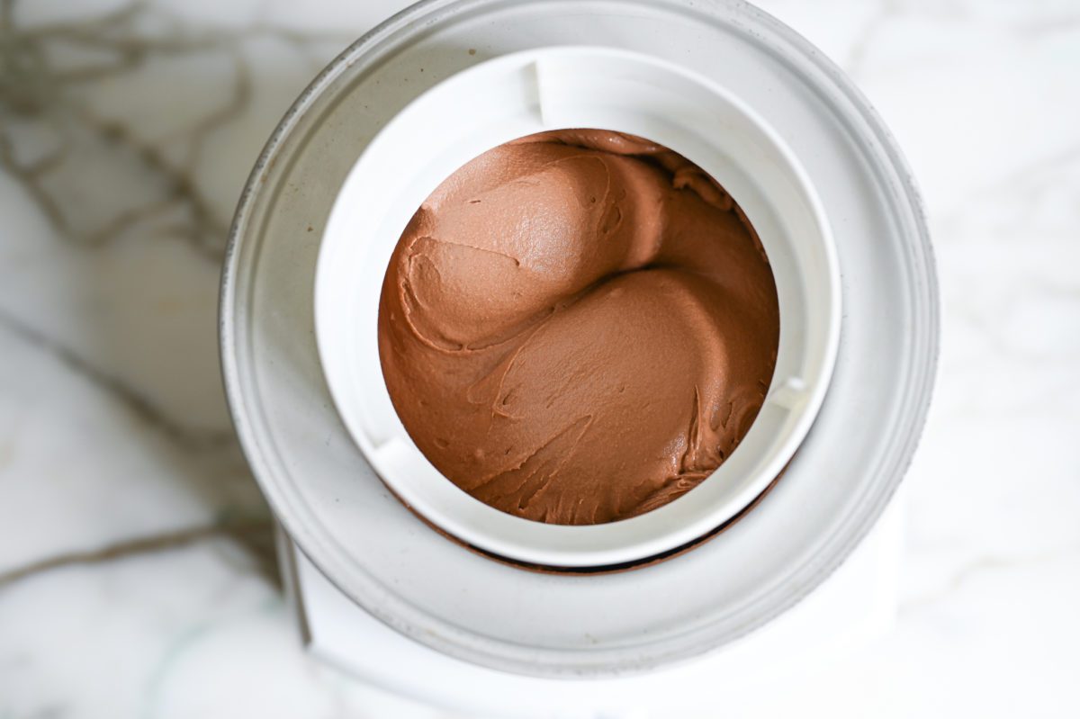 churning chocolate ice cream in ice cream machine