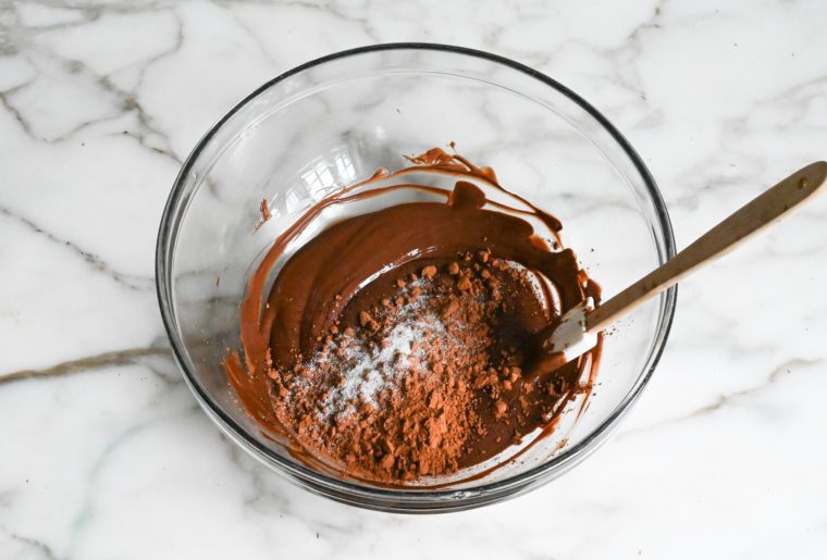 adding cocoa powder and salt to melted chocolate