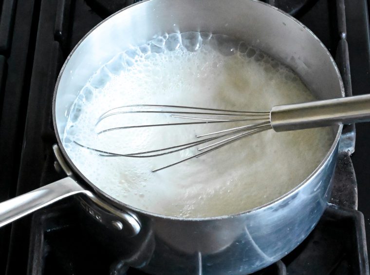 cream, milk, and corn syrup boiling in pan