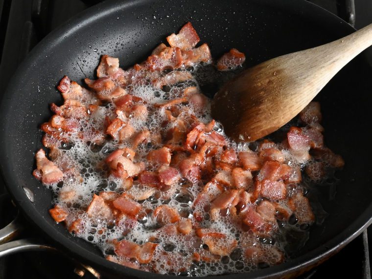 sizzling crispy bacon in skillet