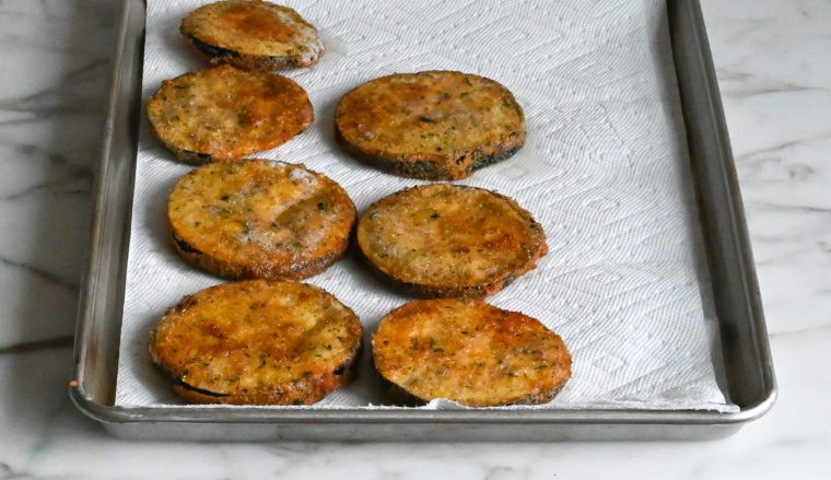 draining fried eggplant on paper towels