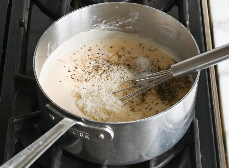 whisking in parmesan cheese, salt and pepper