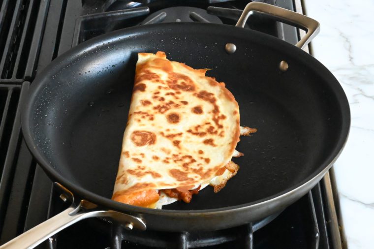 toasting outside of quesadilla in skillet