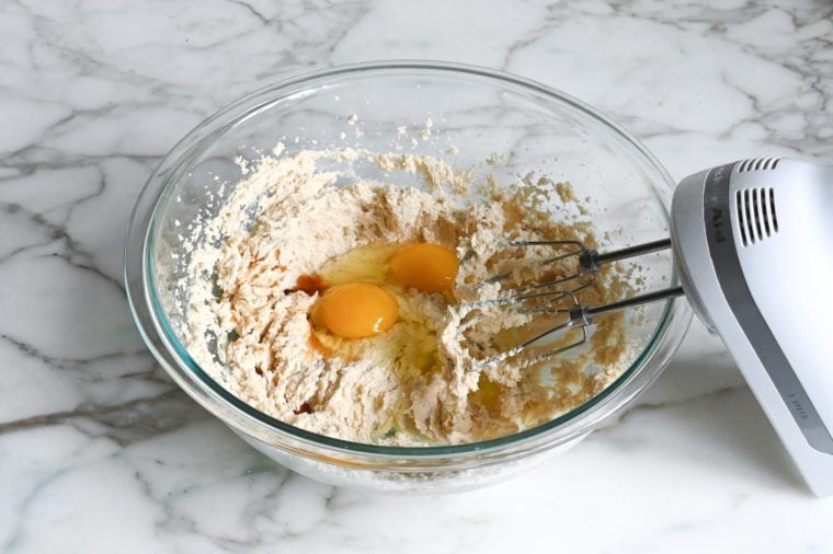 adding the eggs and vanilla to the batter