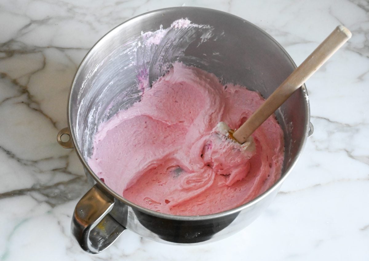 pressing the macaron batter against the sides and bottom of the bowl to release air bubbles (macronage)