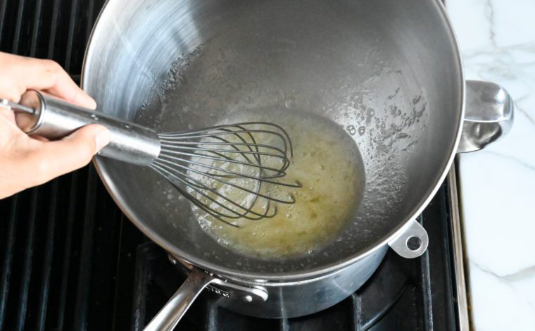 whisking eggs and sugar in a double boiler