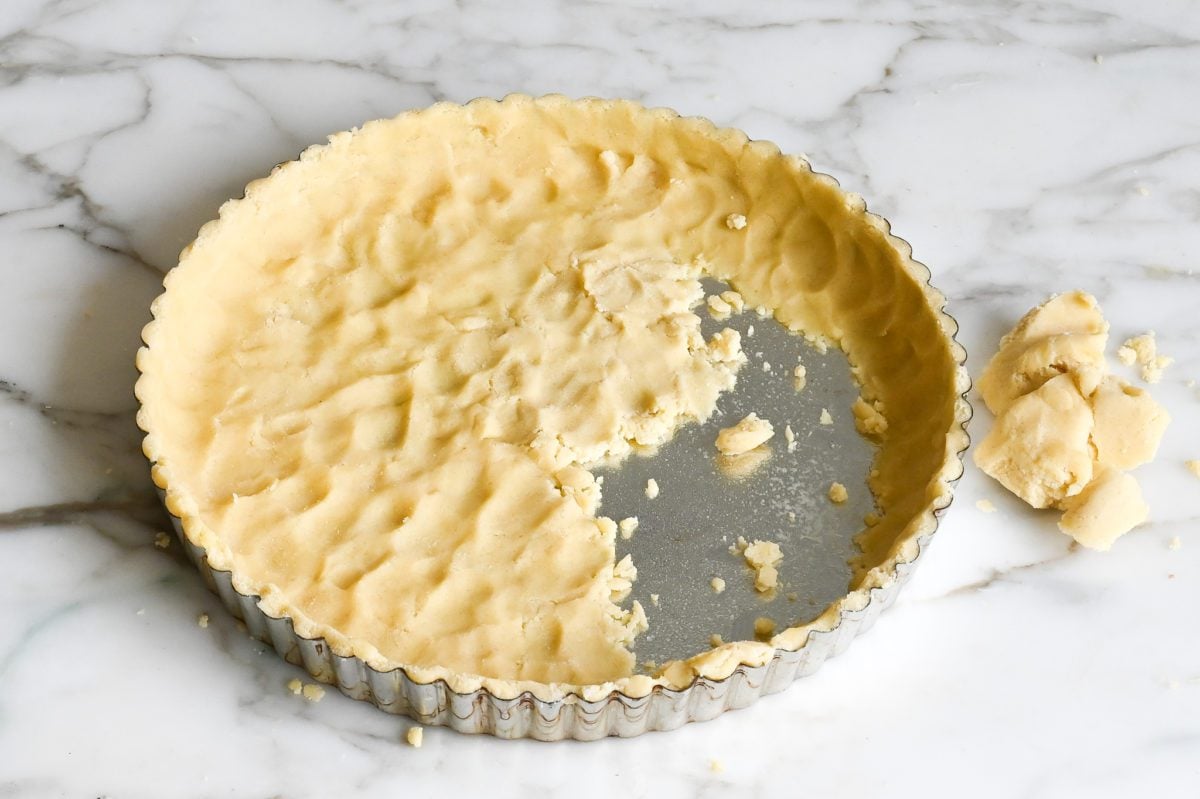 Crumbly tart dough in tart pan.