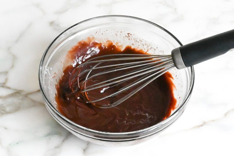 Whisk in a bowl of chocolate glaze.
