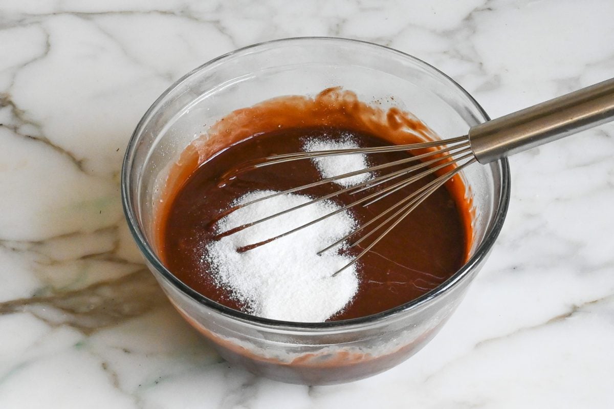 Adding the sugar and salt to the chocolate mixture.