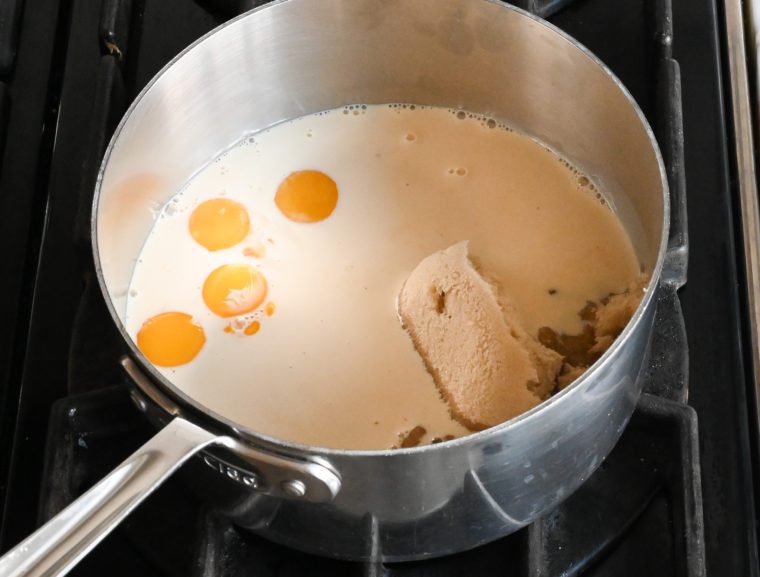 egg yolks, brown sugar, and condensed milk in pot