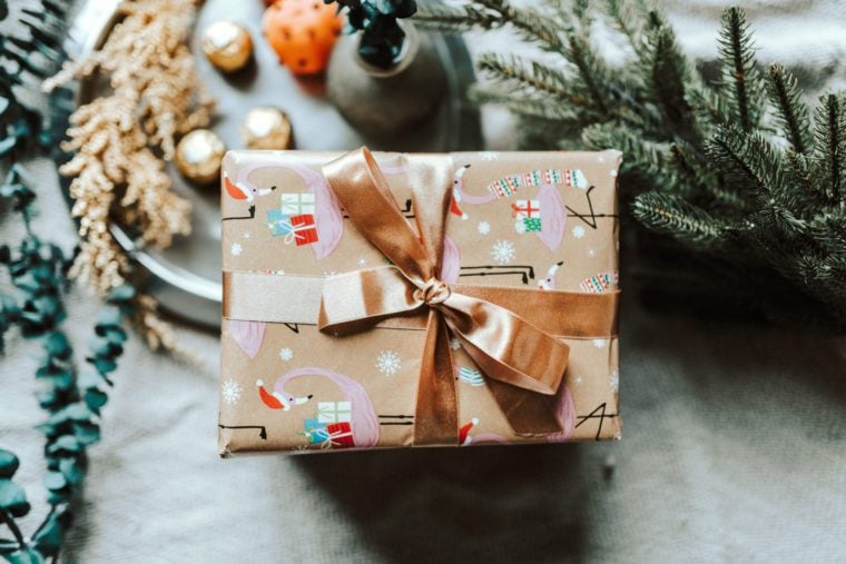 Wrapped present with a bronze-colored ribbon.