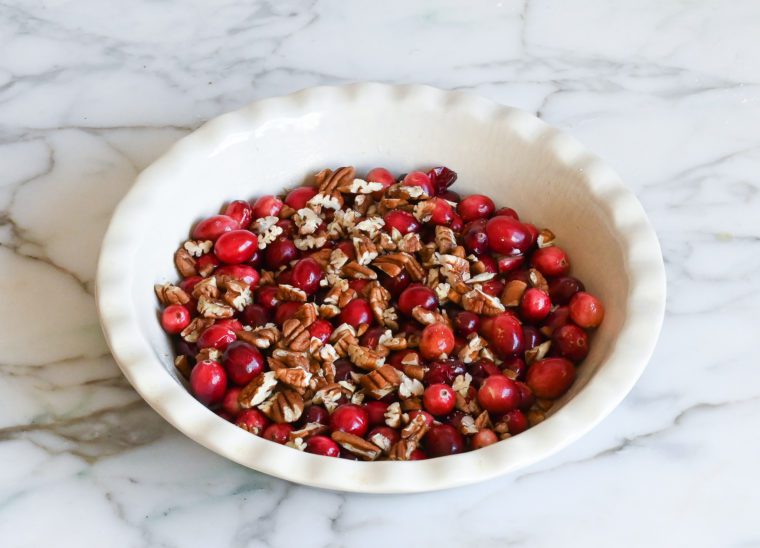 cranberries and pecans in buttered pie dish
