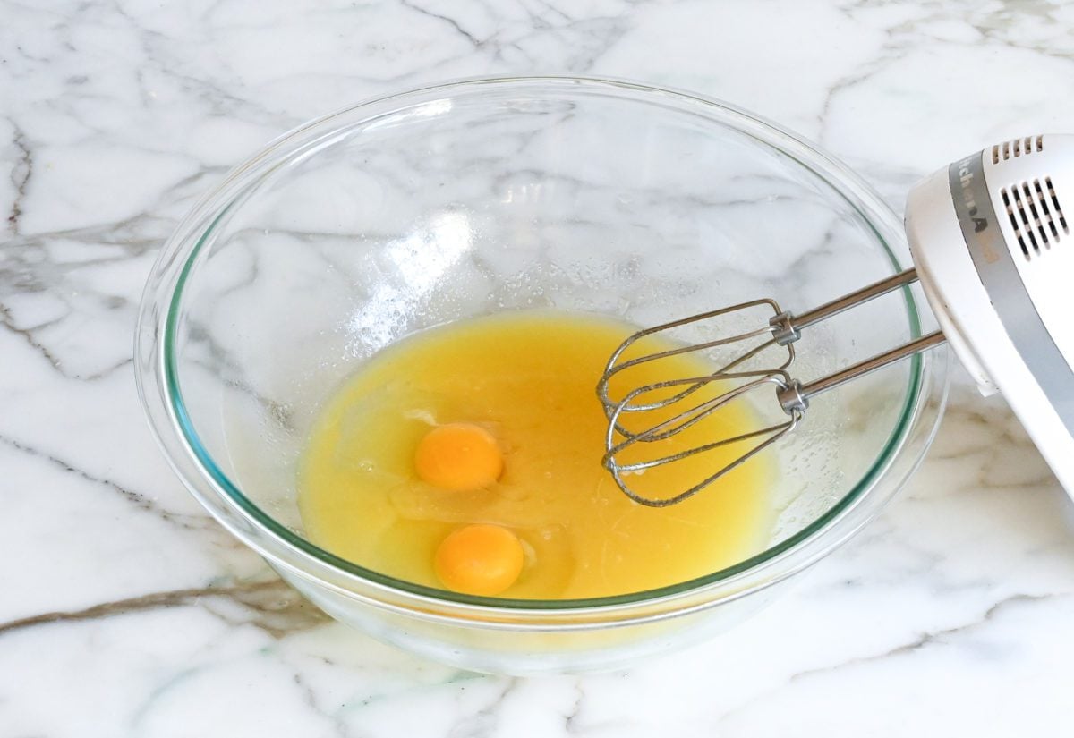 adding the eggs, vanilla, and almond extracts