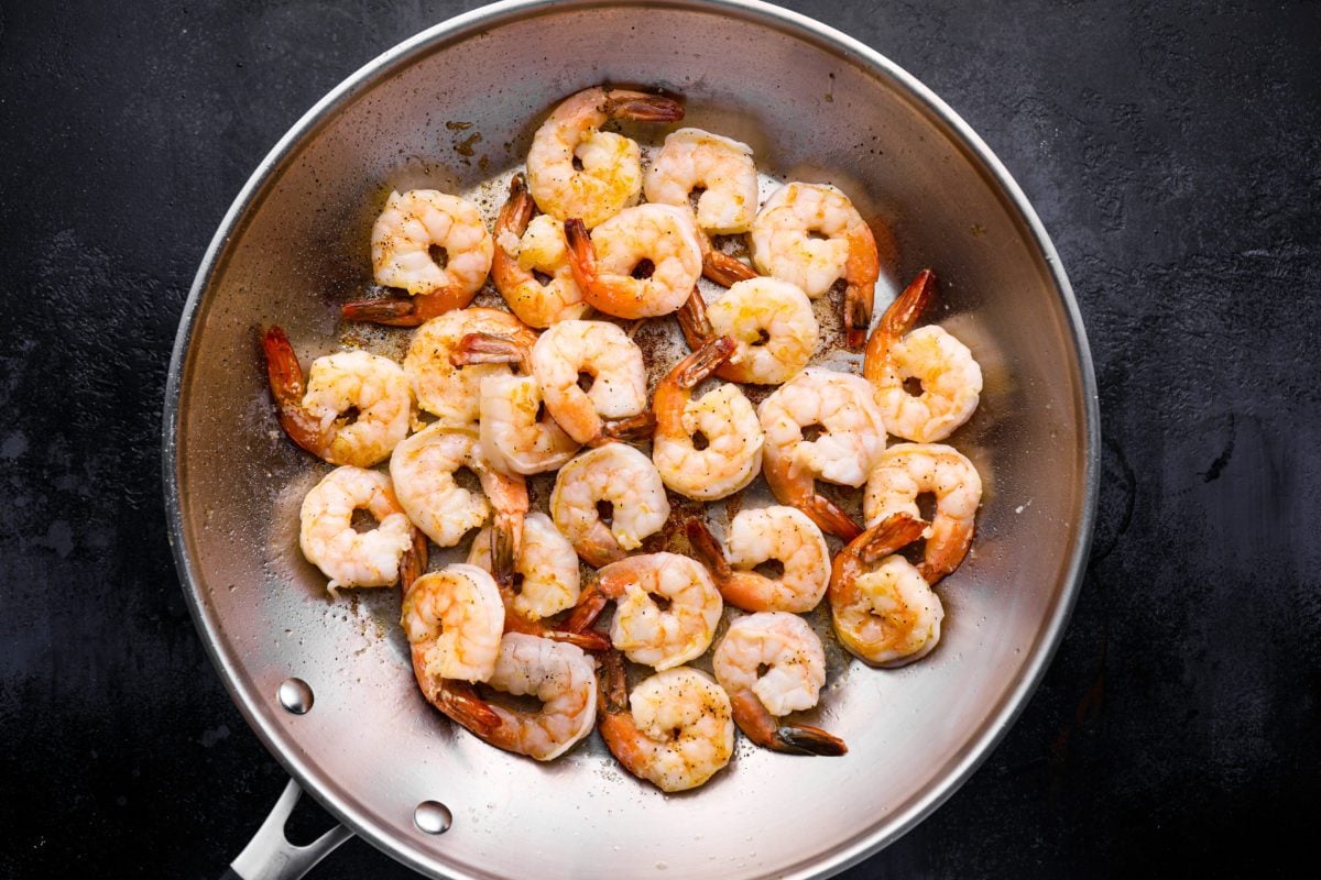 Shrimp cooking in a skillet.