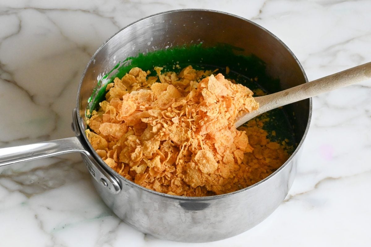 adding cornflakes to marshmallow mixture