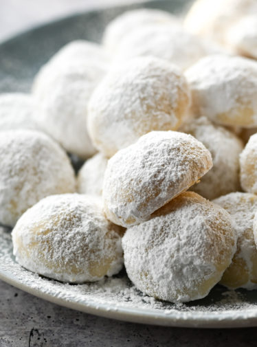 Snowball cookies piled on a plate.
