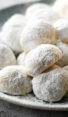 Snowball cookies piled on a plate.