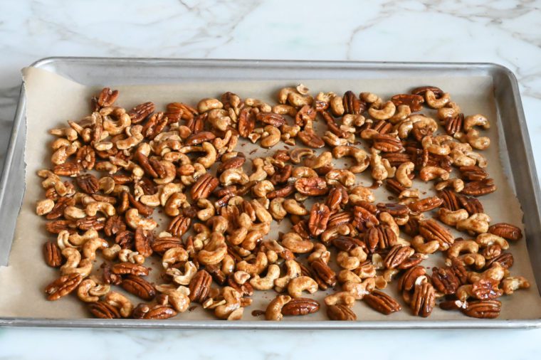 spiced nuts arranged in single layer on baking sheet