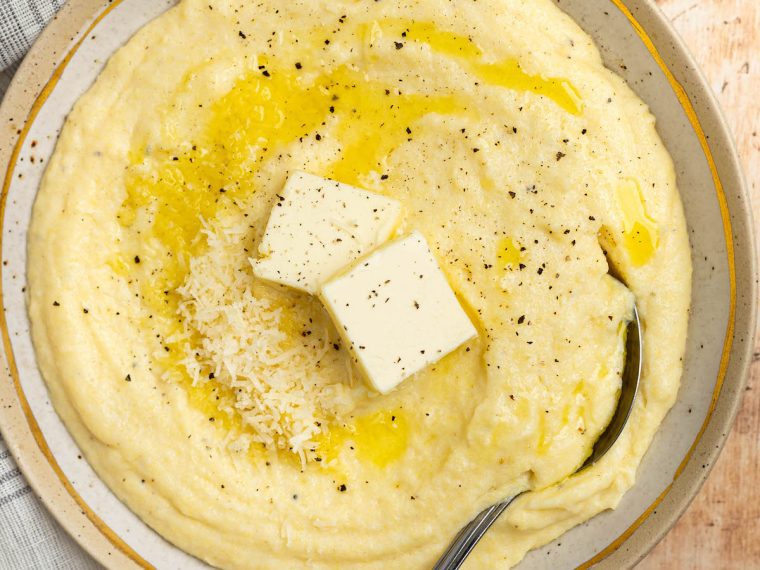 bowl of polenta with butter and parmesan cheese.