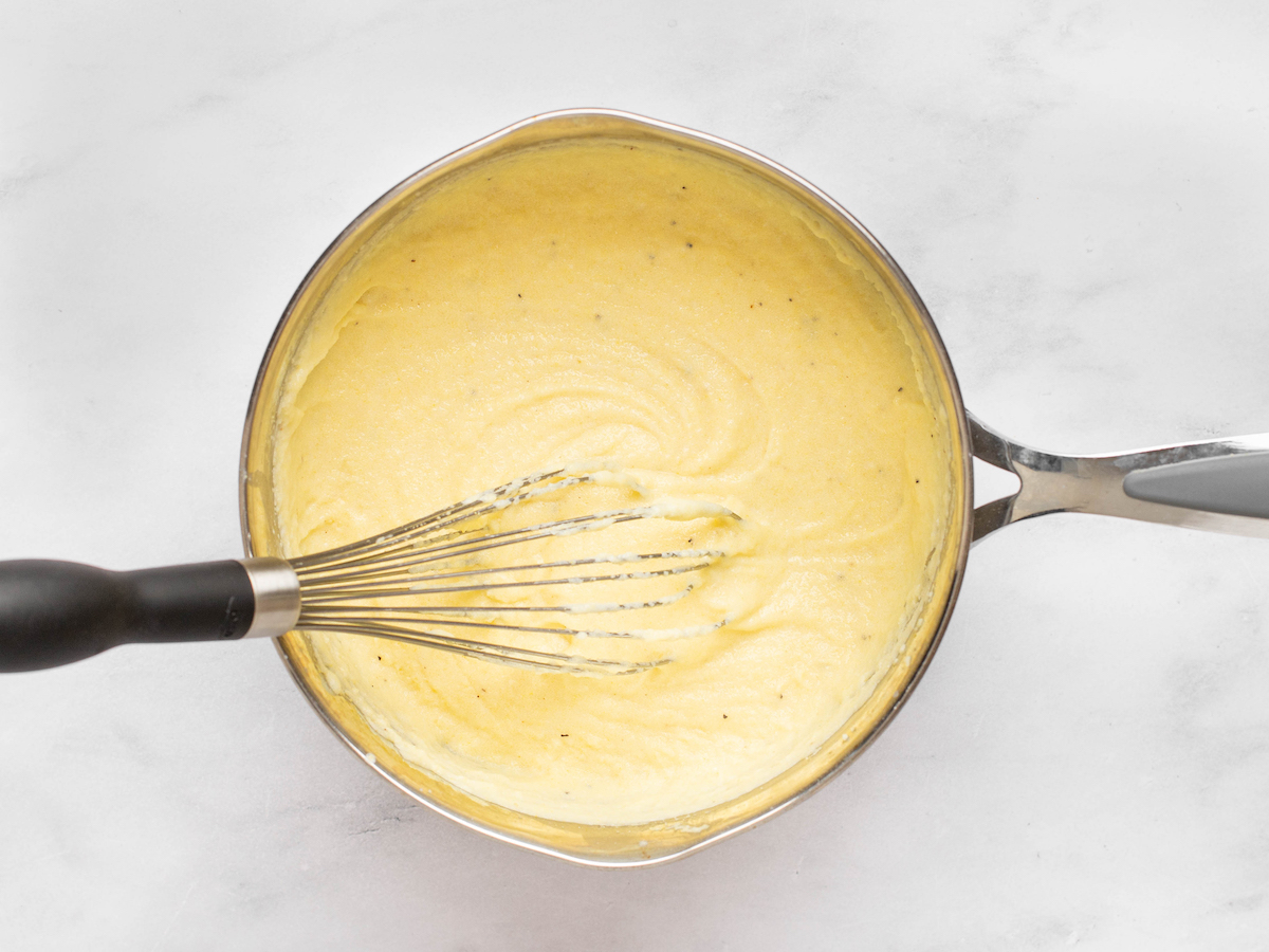 whisking polenta as it cooks.