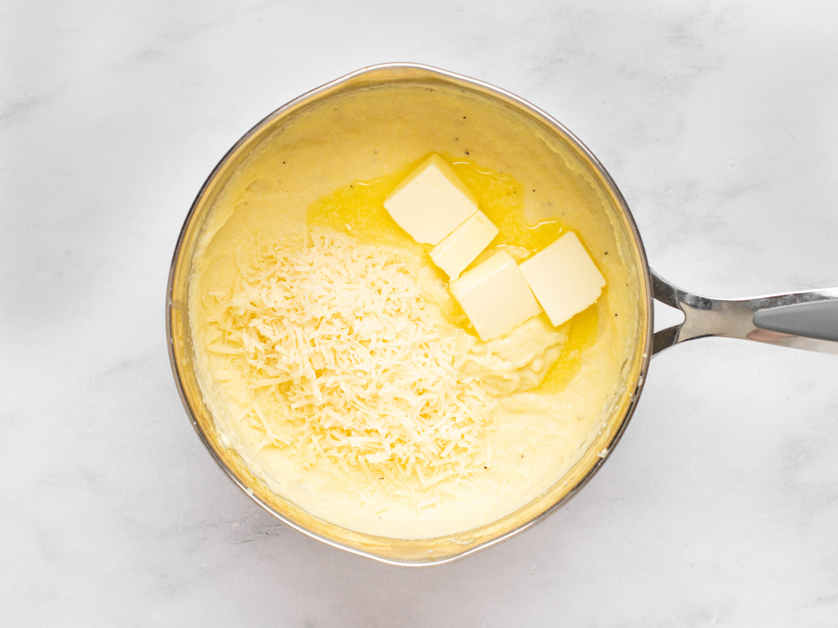adding butter and cheese to the pan.