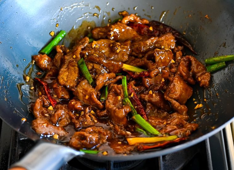 Mongolian beef in a wok.