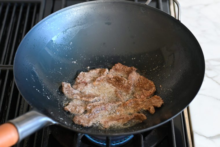 shallow frying beef in wok