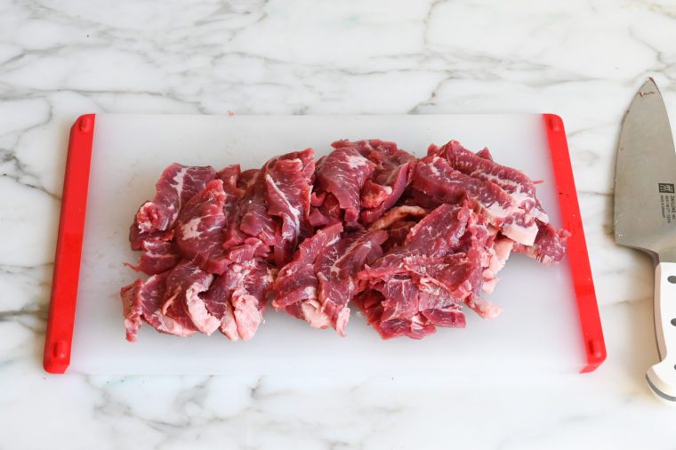 sliced flank steak on cutting board