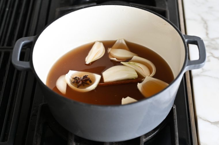 broth, water, fish sauce, onion, ginger, star anise, cloves, sugar, and cinnamon in pot