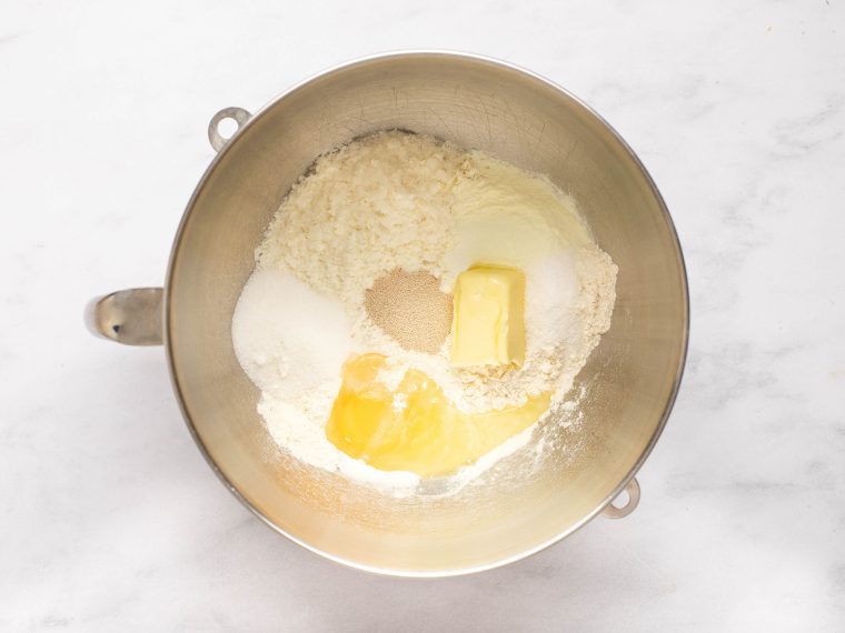 Egg, flour, potato flakes, dried milk, sugar, yeast, salt, and 3 tablespoons of the butter in a mixing bowl