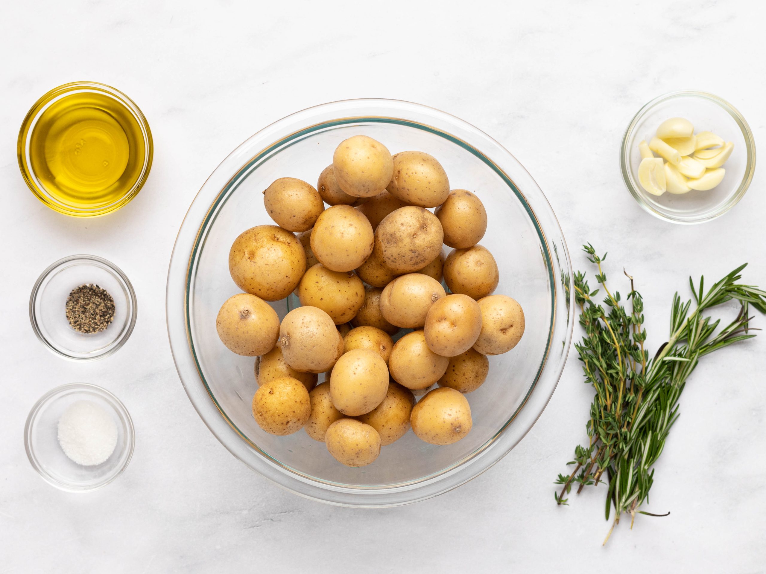 Ingredients to make oven roasted potatoes in bowls.