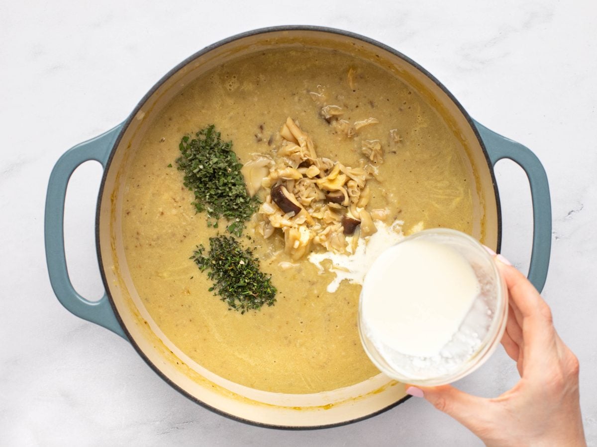 adding the cream, mushrooms and herbs to the cream of mushroom soup