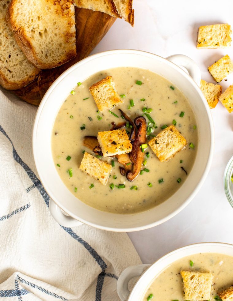 Bowl of cream of mushroom soup with croutons.