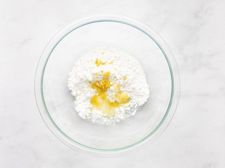 lemon juice, lemon zest, melted butter, and confectioners' sugar in bowl