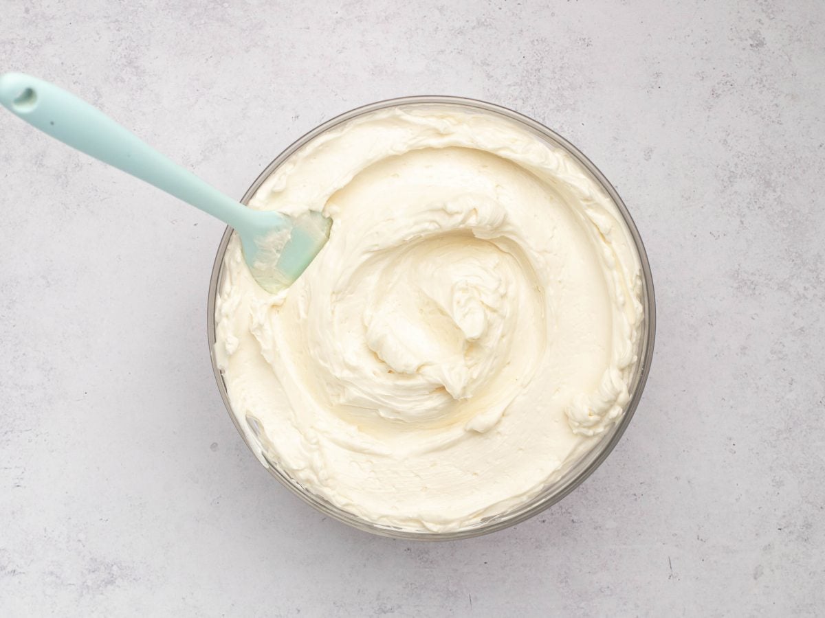 Spatula in a bowl of Swiss meringue buttercream.