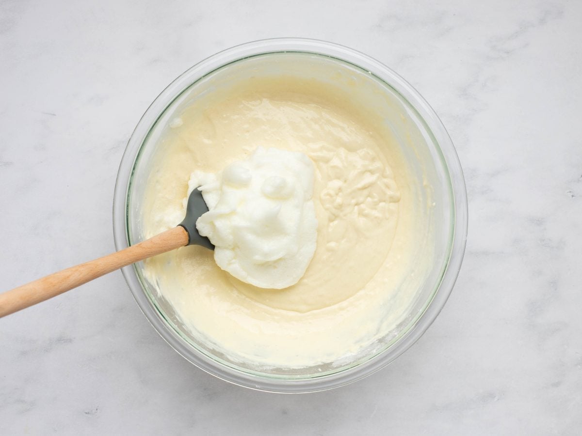 adding the beaten egg whites to the waffle batter.