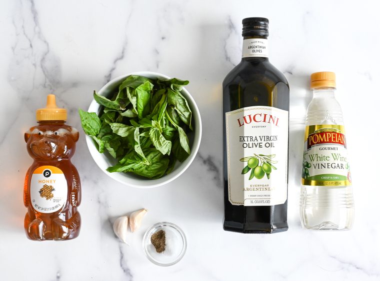 Vinaigrette ingredients, including basil, honey, and olive oil.