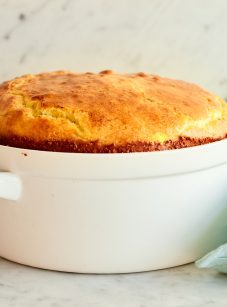 Cheese souffle in a white, handled dish.