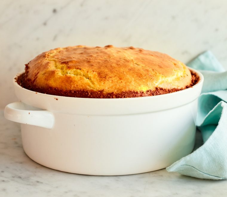 Cheese souffle in a white, handled dish.
