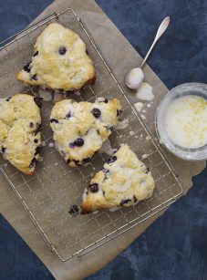 Blueberry scones on a wire rack.