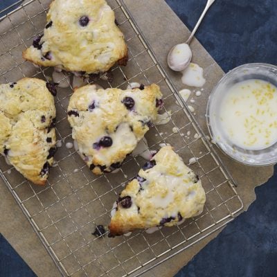 Blueberry scones on a wire rack.